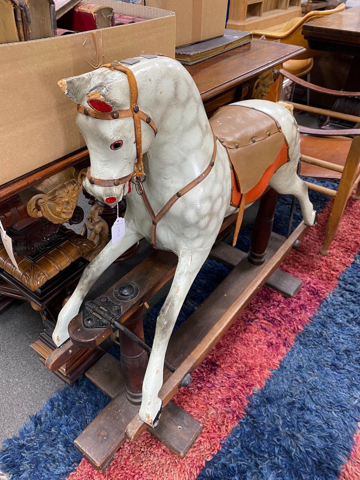 An early 20th century carved wood dapple grey rocking horse on safety frame, height 95cm
